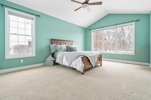 carpeted bedroom featuring multiple windows, ceiling fan, and vaulted ceiling