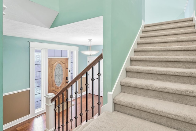 staircase featuring wood-type flooring