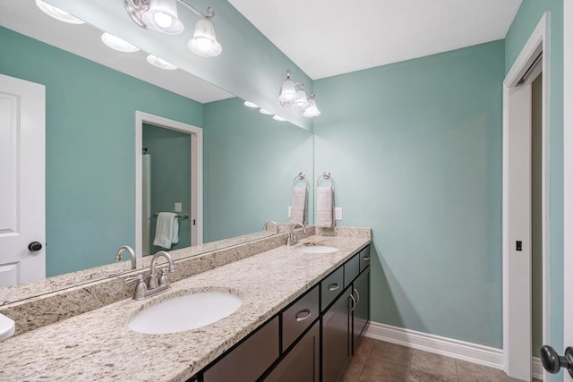 bathroom with tile patterned floors and vanity