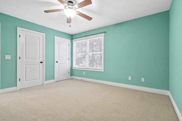 unfurnished bedroom with ceiling fan and light carpet