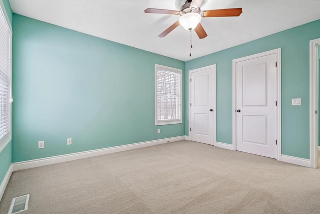 unfurnished bedroom featuring ceiling fan and light colored carpet