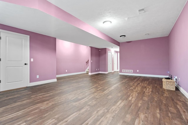 interior space with dark hardwood / wood-style flooring and a textured ceiling