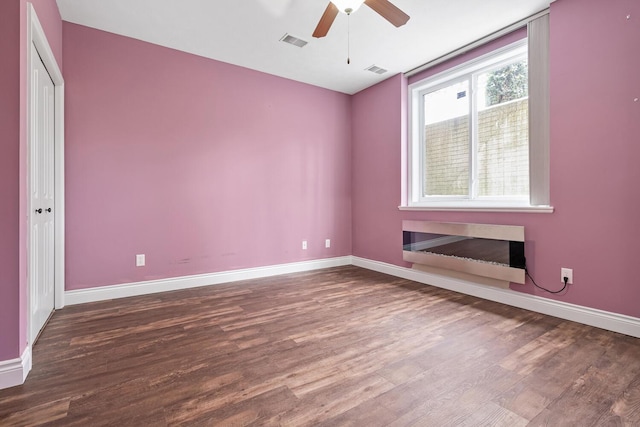 spare room with hardwood / wood-style floors and ceiling fan