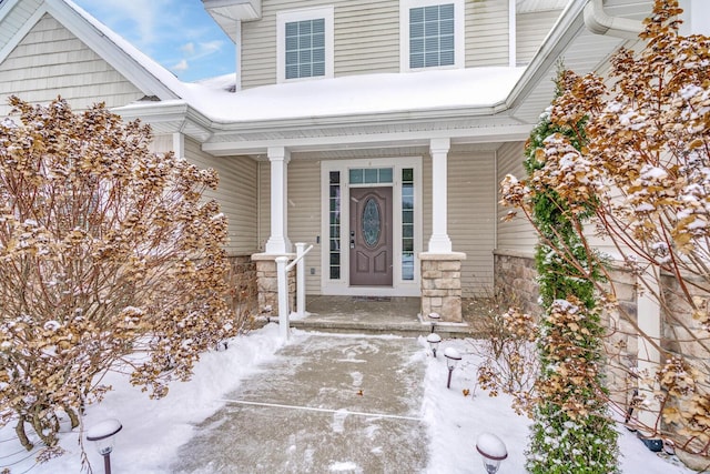 view of snow covered property entrance