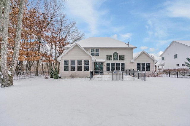 view of snow covered back of property