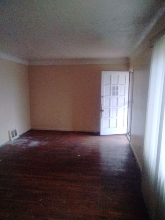 unfurnished room featuring crown molding