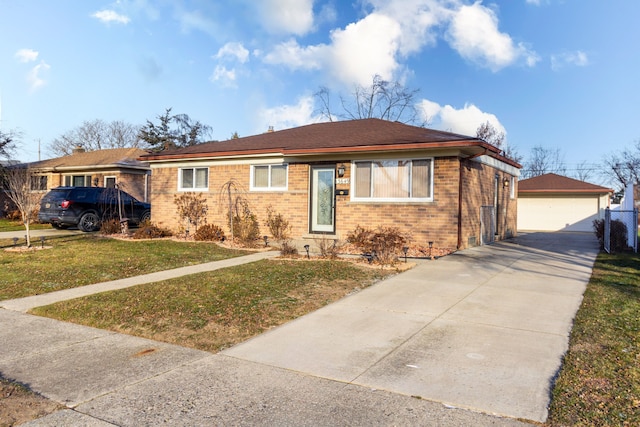 ranch-style home with a garage, an outbuilding, and a front yard