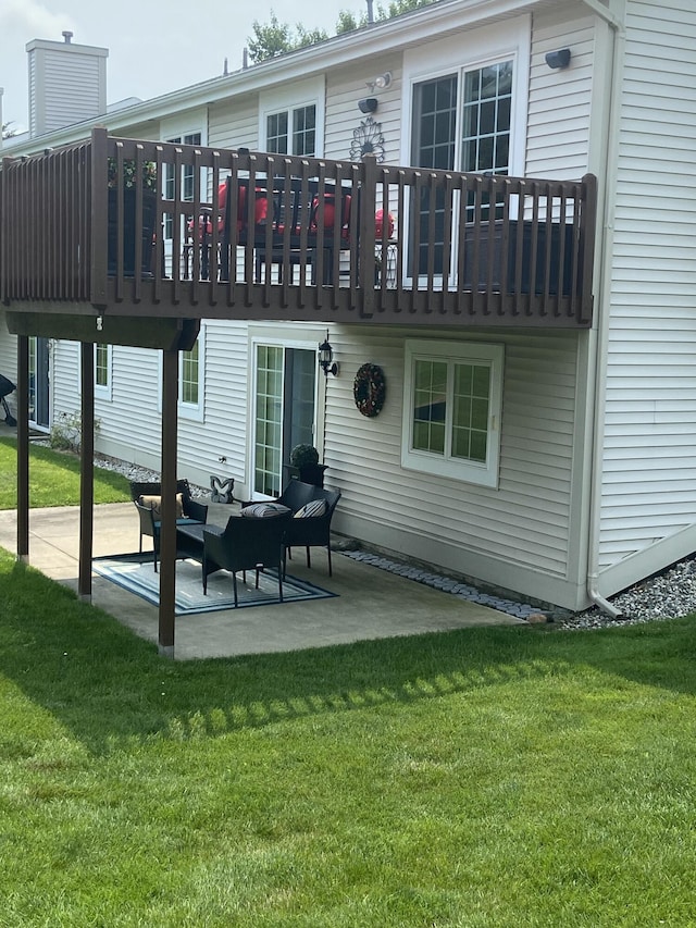 back of house with a yard and a patio area