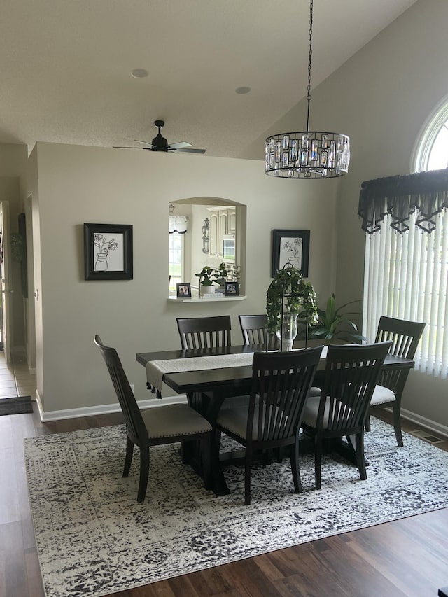 dining space featuring ceiling fan, vaulted ceiling, and hardwood / wood-style flooring