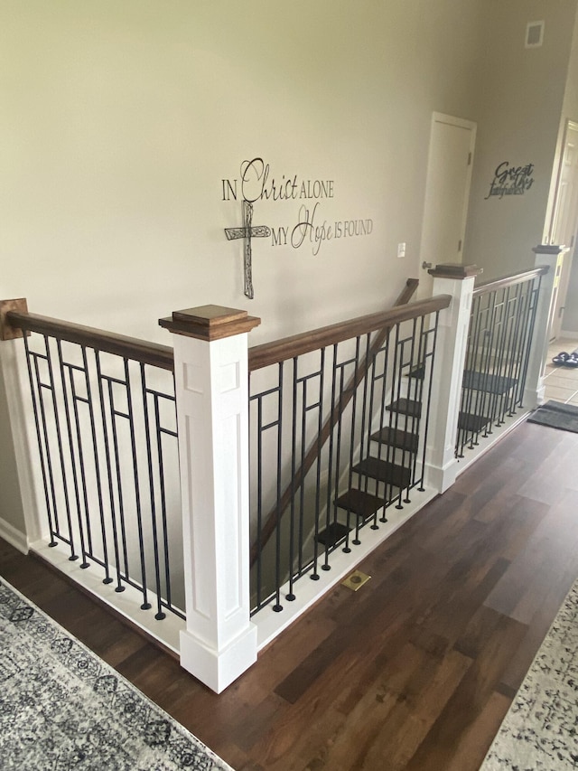 stairs featuring hardwood / wood-style floors