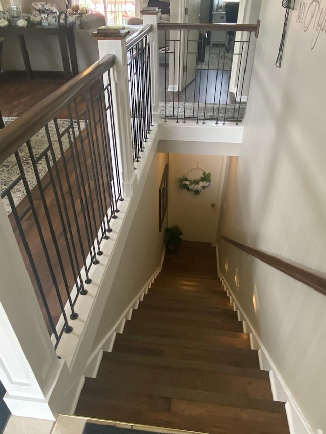 stairs featuring wood-type flooring