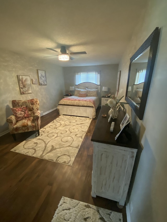 bedroom with dark hardwood / wood-style floors and ceiling fan