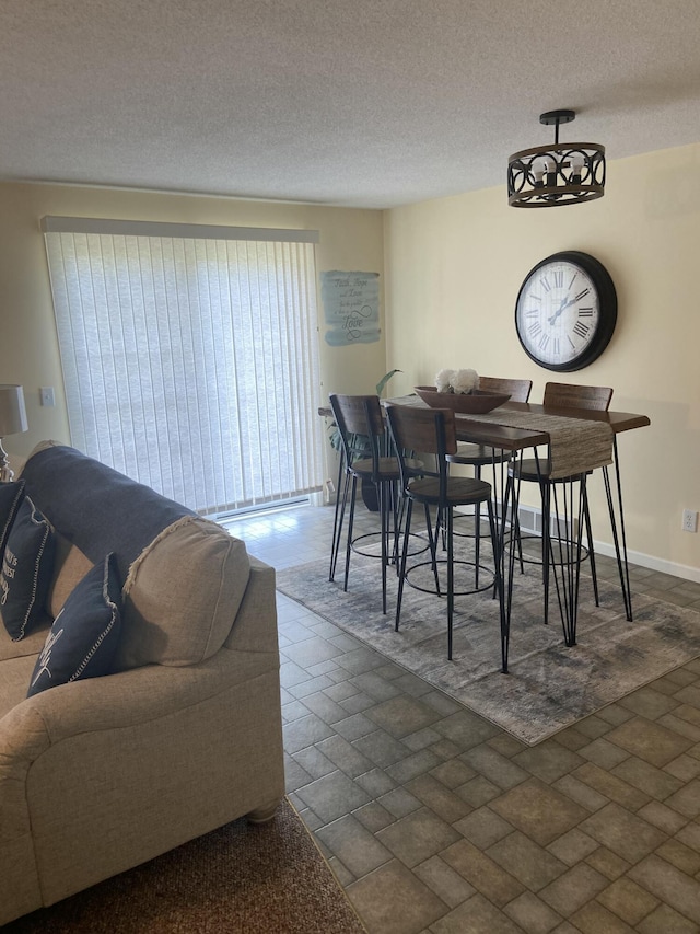 dining space with a textured ceiling