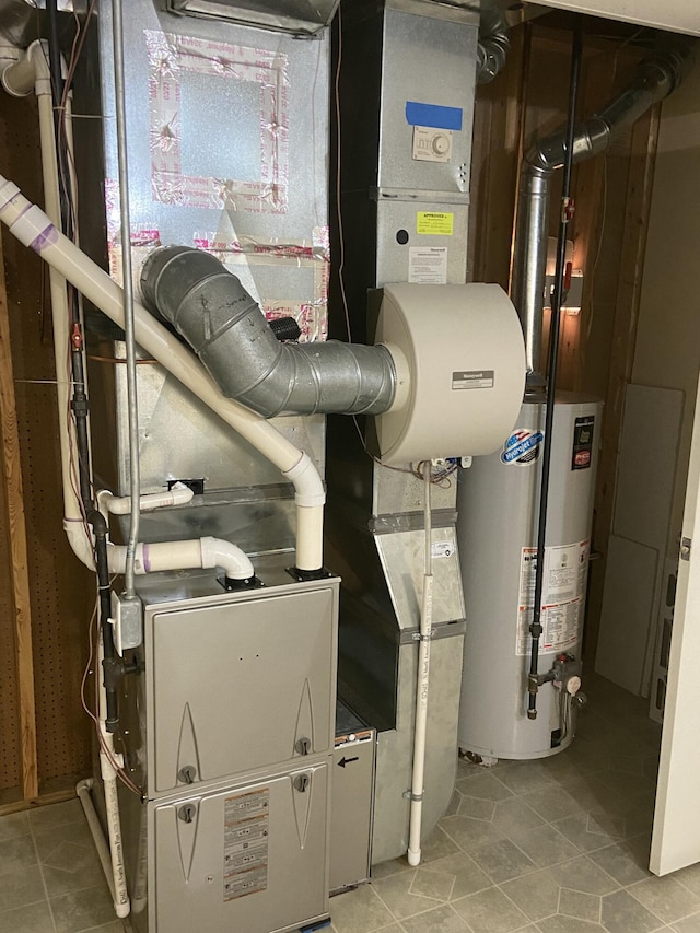 utility room featuring gas water heater