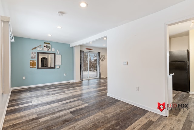 empty room with dark wood-type flooring