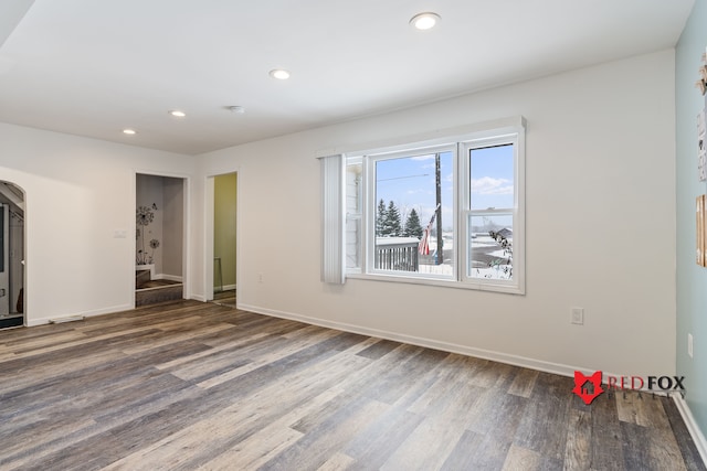 spare room with dark hardwood / wood-style floors