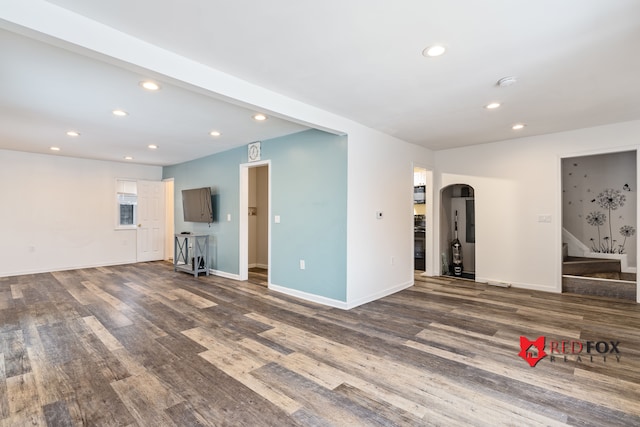 unfurnished living room with dark hardwood / wood-style floors