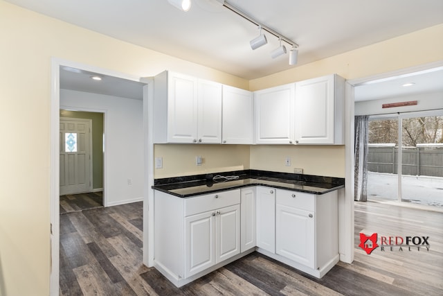 kitchen featuring white cabinets and dark hardwood / wood-style floors