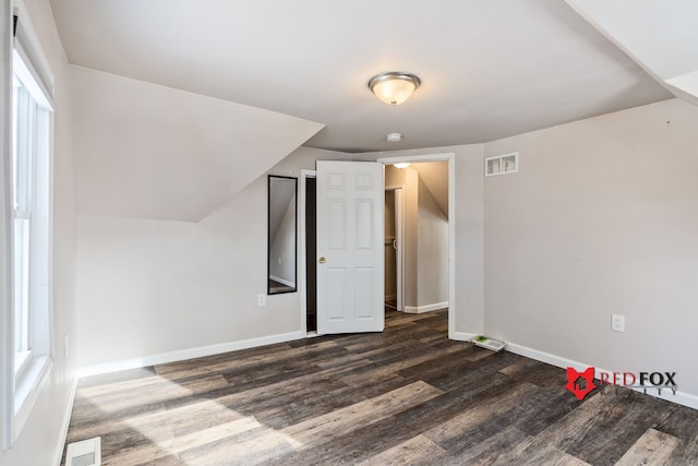 bonus room with dark hardwood / wood-style flooring