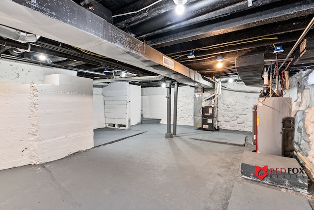 basement featuring heating unit and water heater