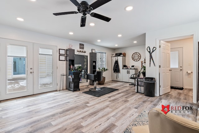 exercise area with french doors, light wood-type flooring, and ceiling fan