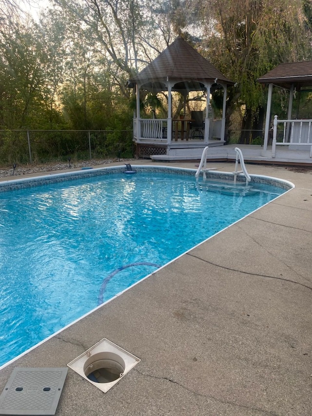 view of swimming pool featuring a gazebo and a patio area