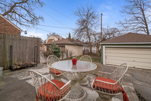 view of patio / terrace with an outdoor structure and a garage