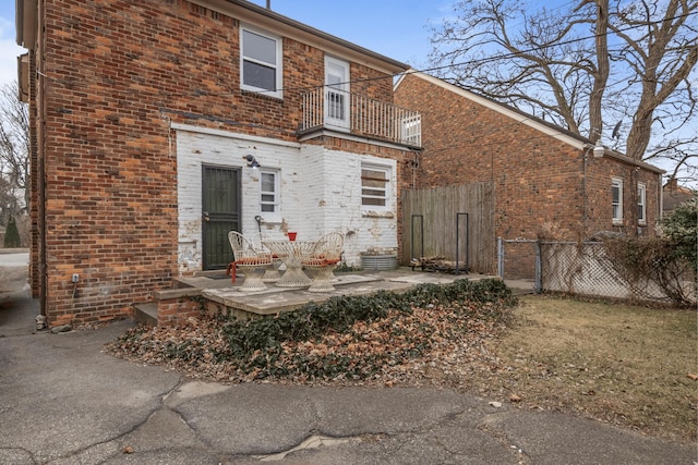 rear view of property featuring a balcony