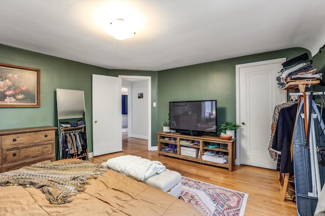 bedroom featuring light hardwood / wood-style floors and a closet