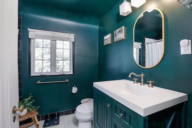 bathroom featuring tile patterned flooring, a shower with curtain, vanity, and toilet