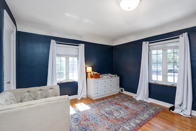 living area with plenty of natural light and light hardwood / wood-style flooring