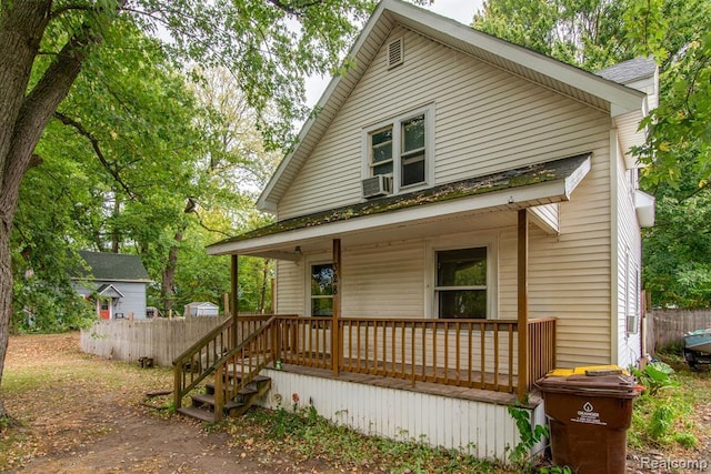 back of property featuring cooling unit and covered porch