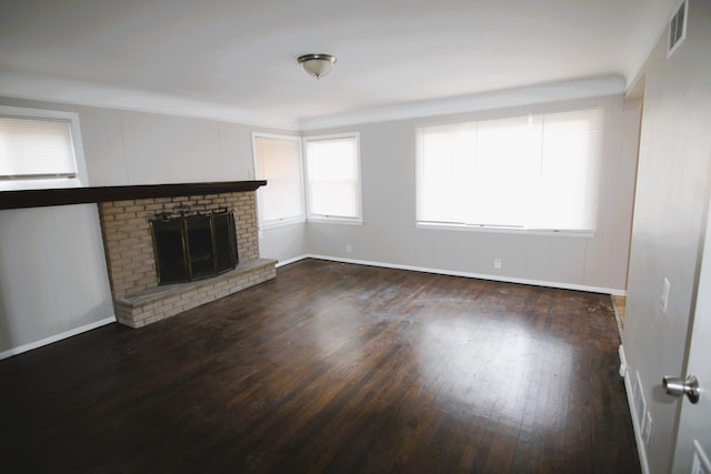 unfurnished living room with dark hardwood / wood-style floors and a fireplace