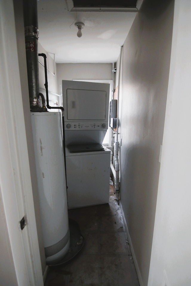 interior space with water heater and stacked washer / drying machine