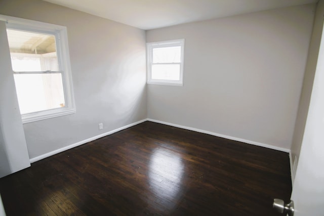 empty room featuring dark hardwood / wood-style flooring