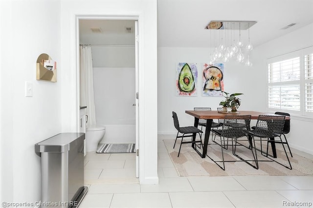 dining area featuring light tile patterned flooring