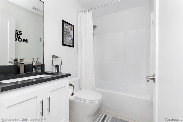 full bathroom with tile patterned flooring, vanity, toilet, and shower / bath combo with shower curtain