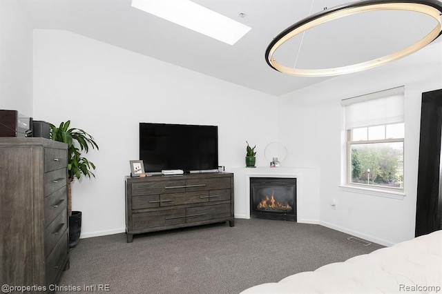 carpeted bedroom with lofted ceiling with skylight