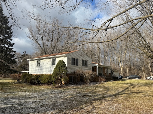 view of home's exterior featuring a garage and a lawn