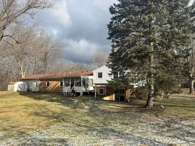 view of front of property with a sunroom and a front lawn