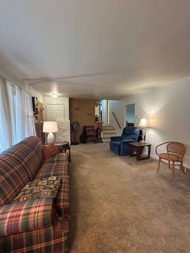 living room featuring carpet and stairs