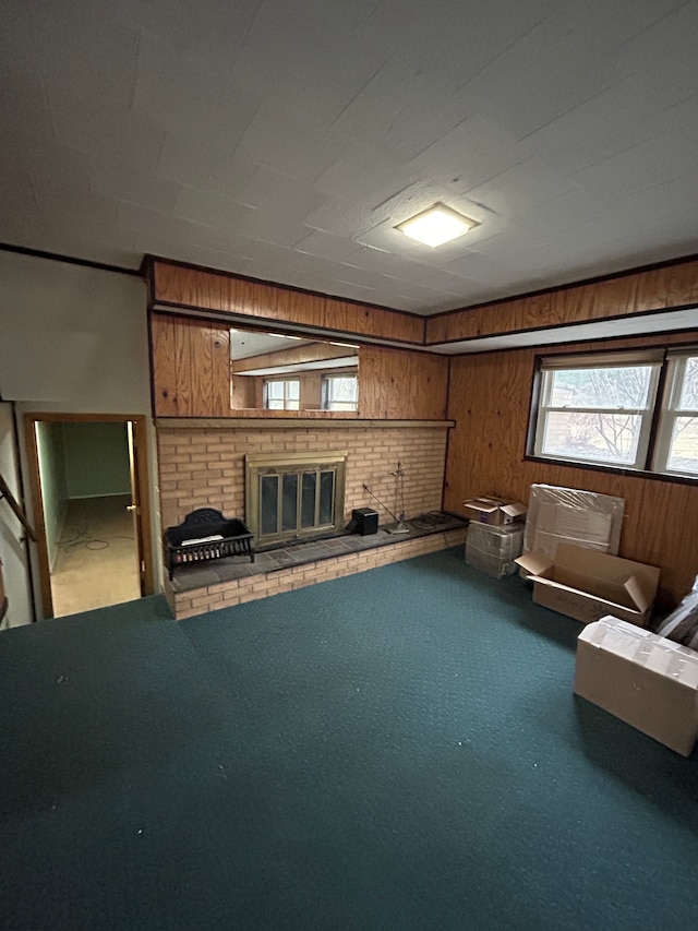 interior space with carpet floors, a brick fireplace, and wooden walls