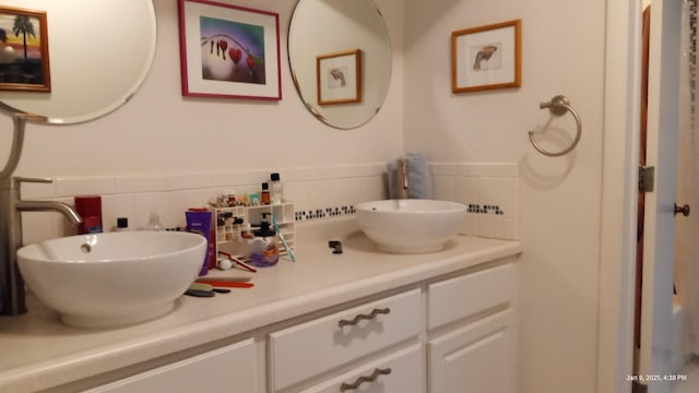 bathroom featuring tasteful backsplash and vanity