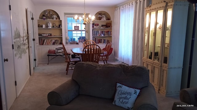 living room featuring light carpet, a notable chandelier, and built in shelves