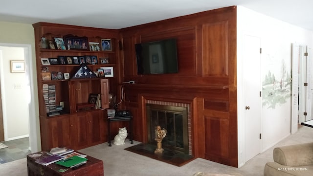 living area with carpet floors and a brick fireplace