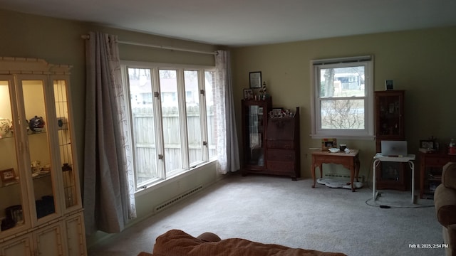 sitting room with a wealth of natural light and light colored carpet