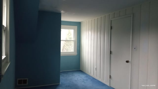 unfurnished bedroom featuring light carpet