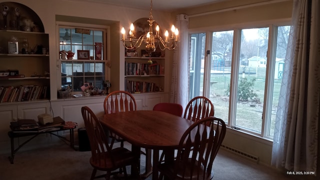 dining area with built in shelves and a chandelier