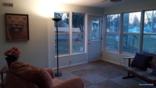 sunroom with visible vents and ceiling fan