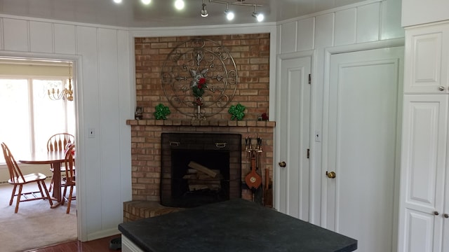 living room with a fireplace and a decorative wall